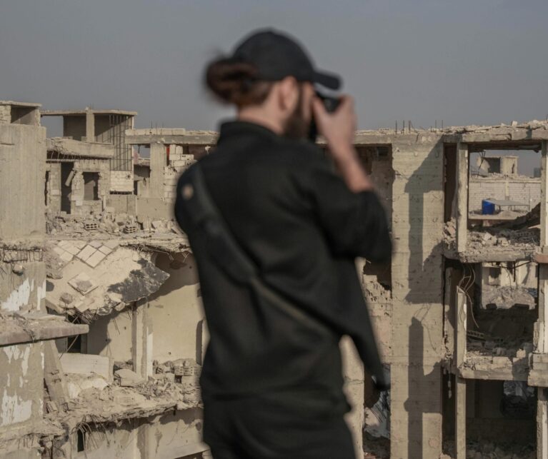 hotographer documenting the war impact on tourism in a conflict-affected destination.
