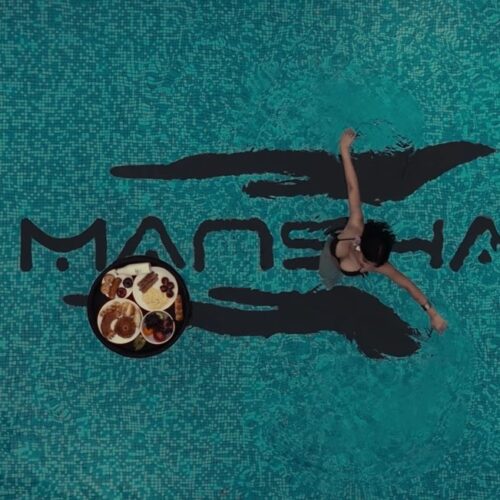 Top view of a swimming pool with Mansha inscribed at the bottom of it